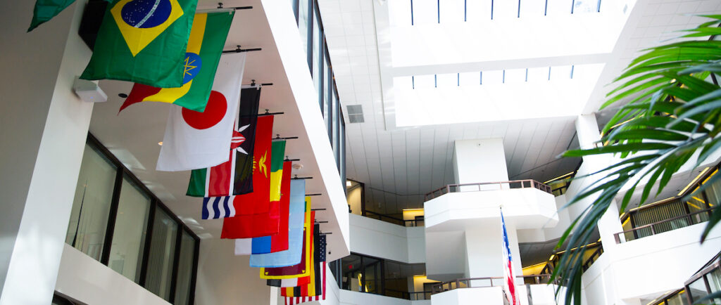 ICC building interior with national flags hanging from the second floor